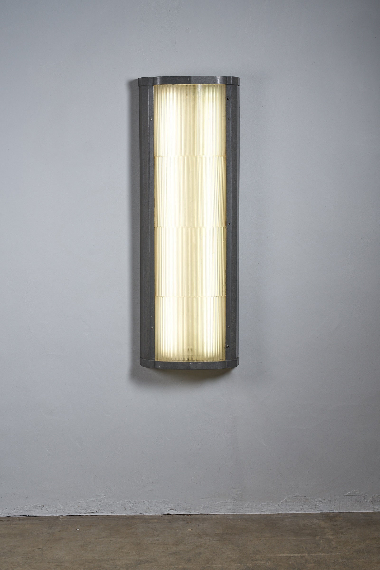 Industrial mount with glass diffuser on a wall