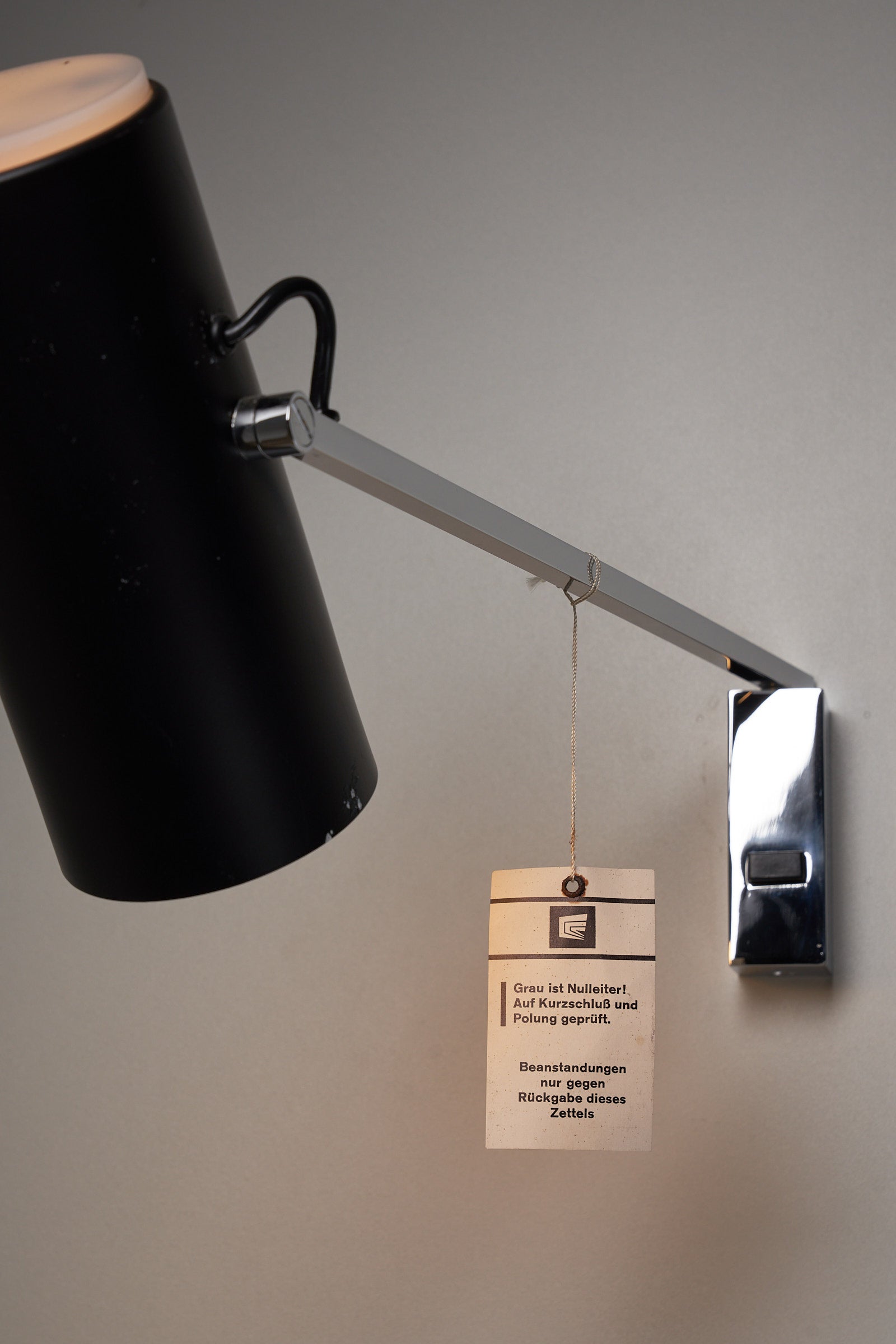 Directional Wall Spot by Cosack Leuchten with black metal shade and chrome wall mount, featuring an adjustable pivot arm for precise lighting.