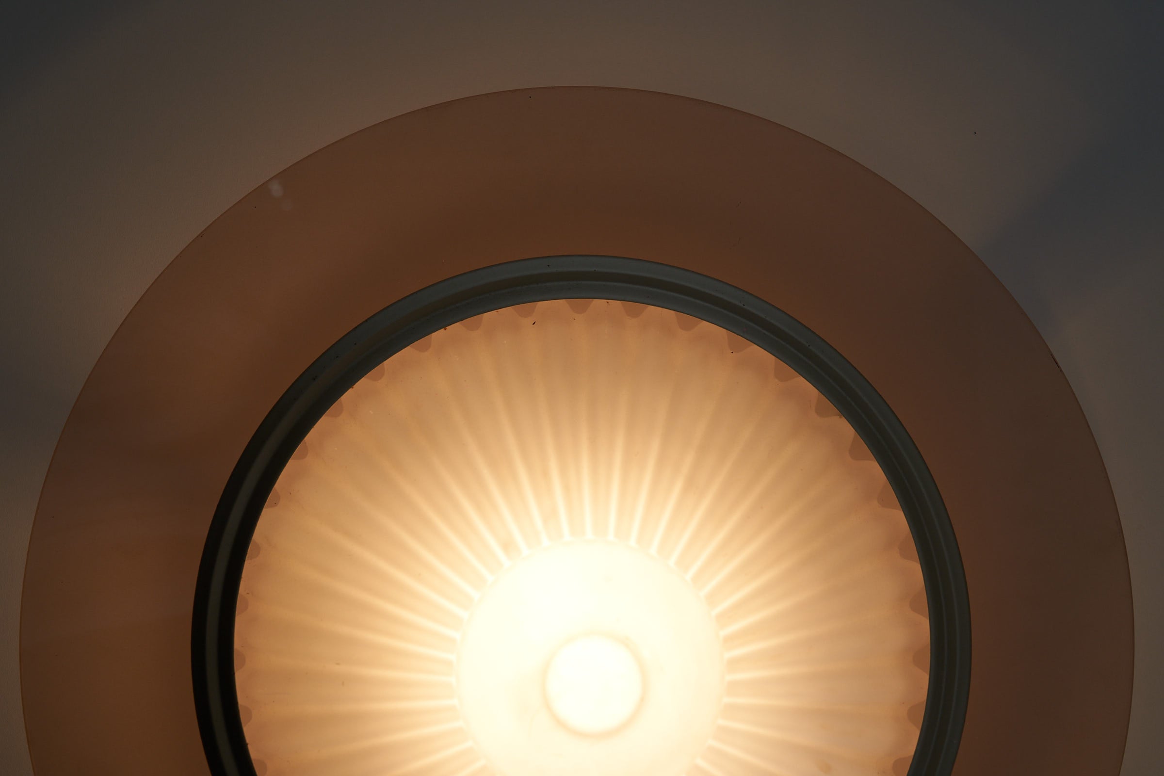 images of the Atena Ceiling Lamp by Ezio Didone for Arteluce, Italy, 1980s. The lamp features a frosted glass cone-shaped diffuser with a colored glass ring around it, separated by a brass ring. The design includes a metal frame that creates a distance between the glass element and the ceiling, producing a backglow effect. The lamp retains its original sticker.