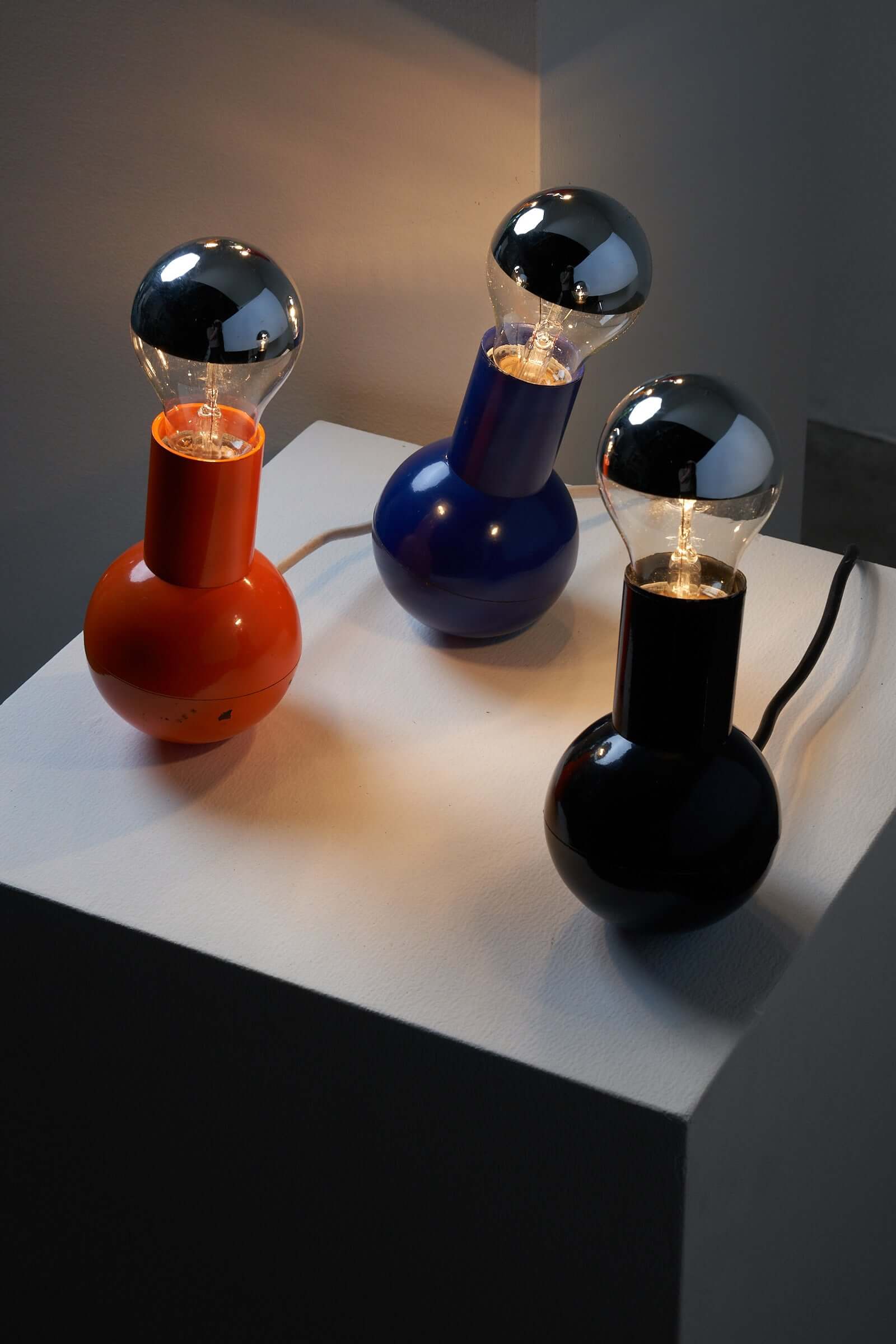 Vibrant Kugel Table Lamp Collection by Cosack Leuchten in orange, blue, and black, showcasing playful and sophisticated design