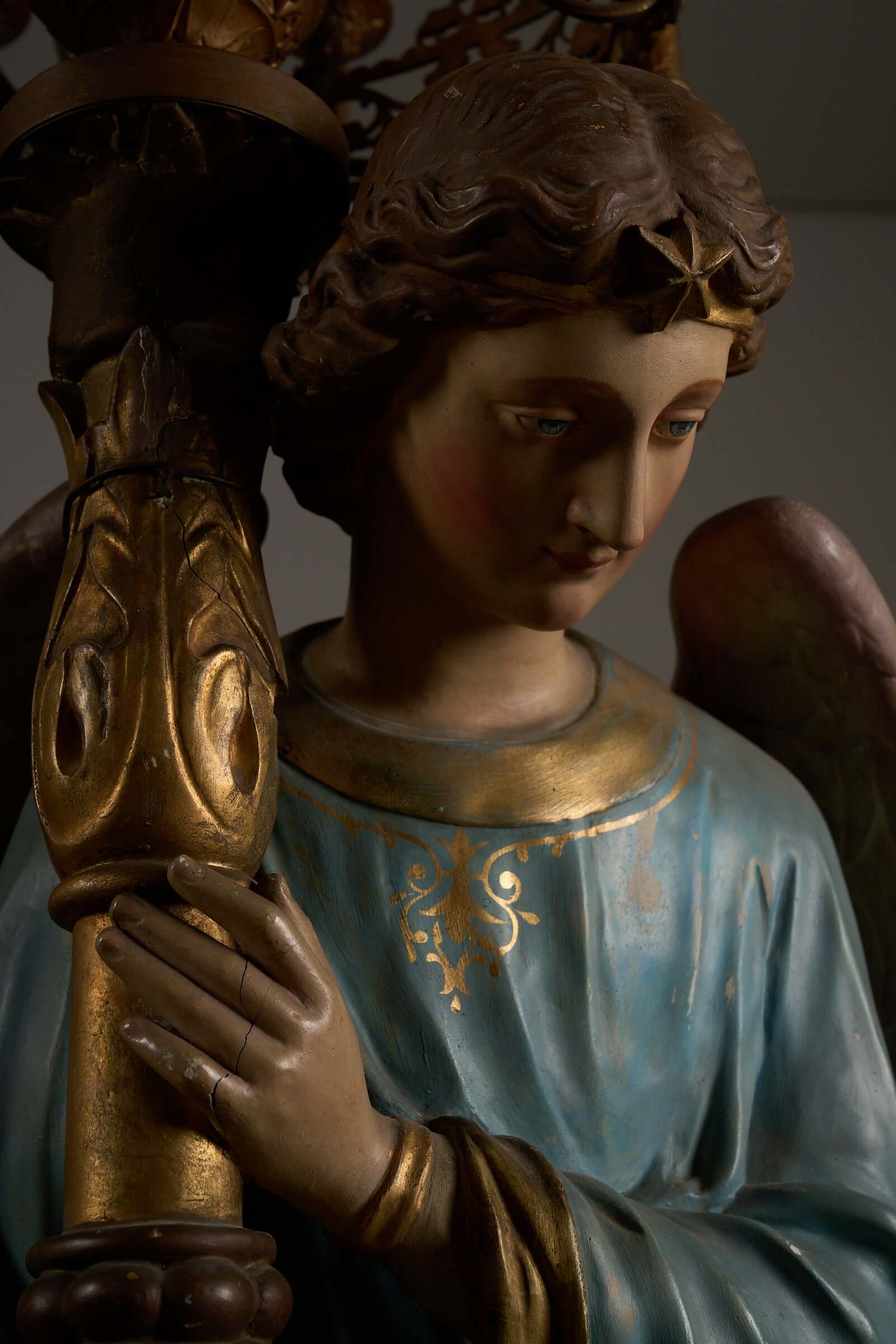 Kneeling angel holding chandelier, 19th century, detailed religious sculpture.