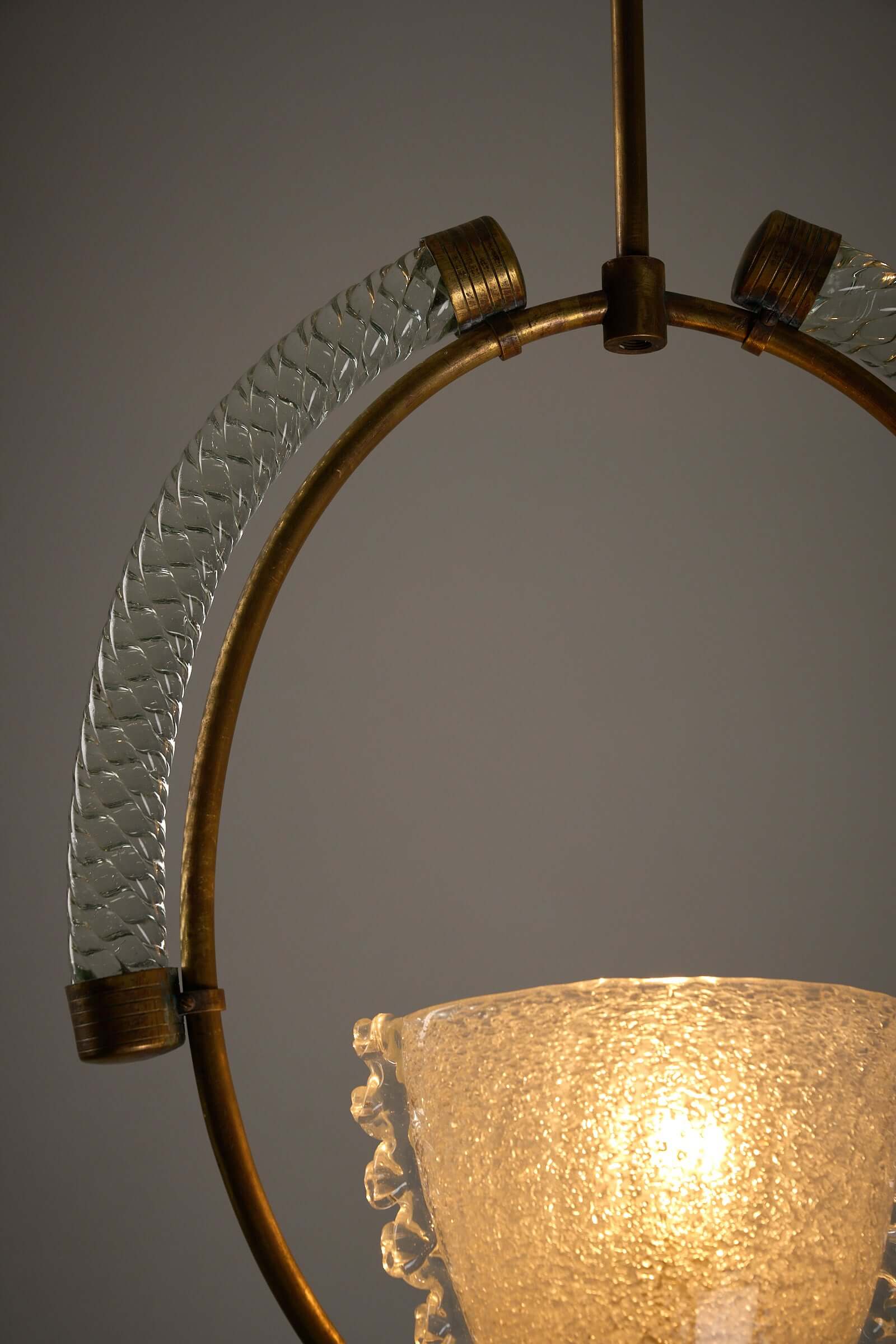 Close-up of Murano glass and brass chandelier from Barovier & Toso showcasing intricate glass texture and vintage brass frame.