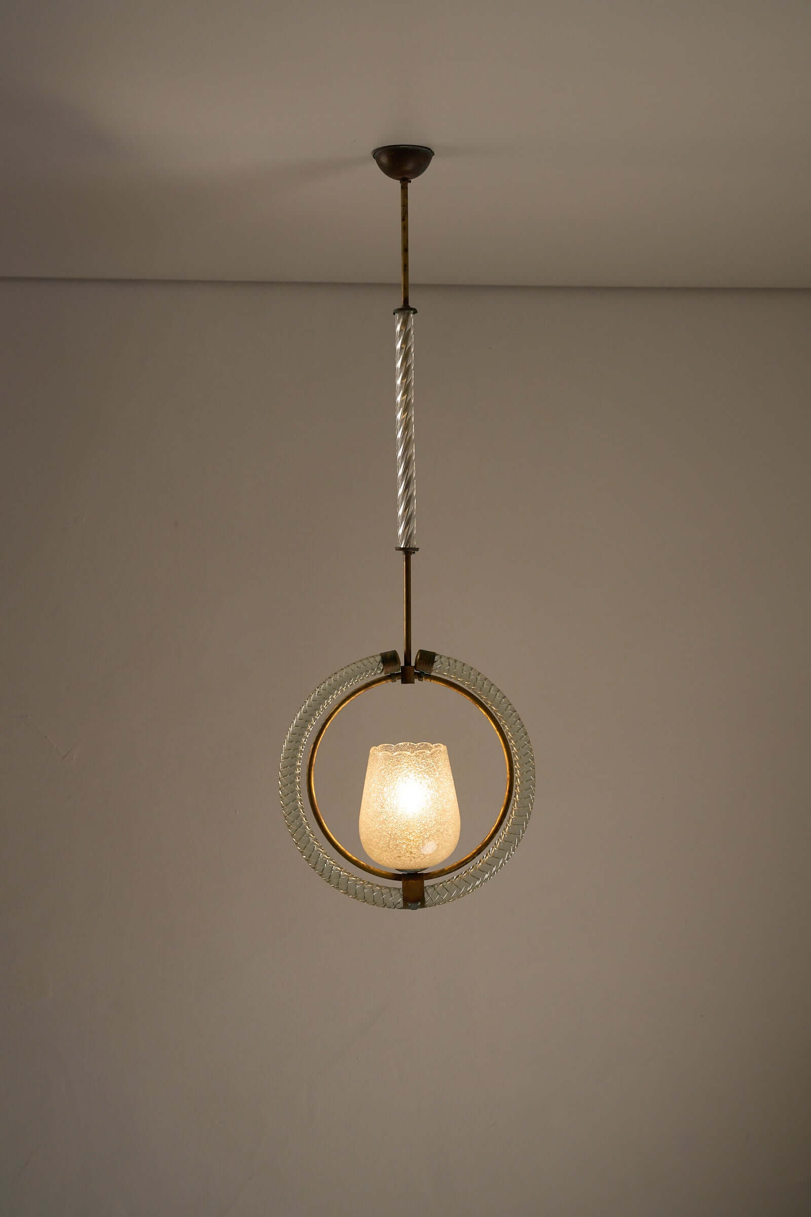 Murano glass and brass chandelier by Barovier & Toso, 1930s, with textured glass shade and circular design, casting warm light.