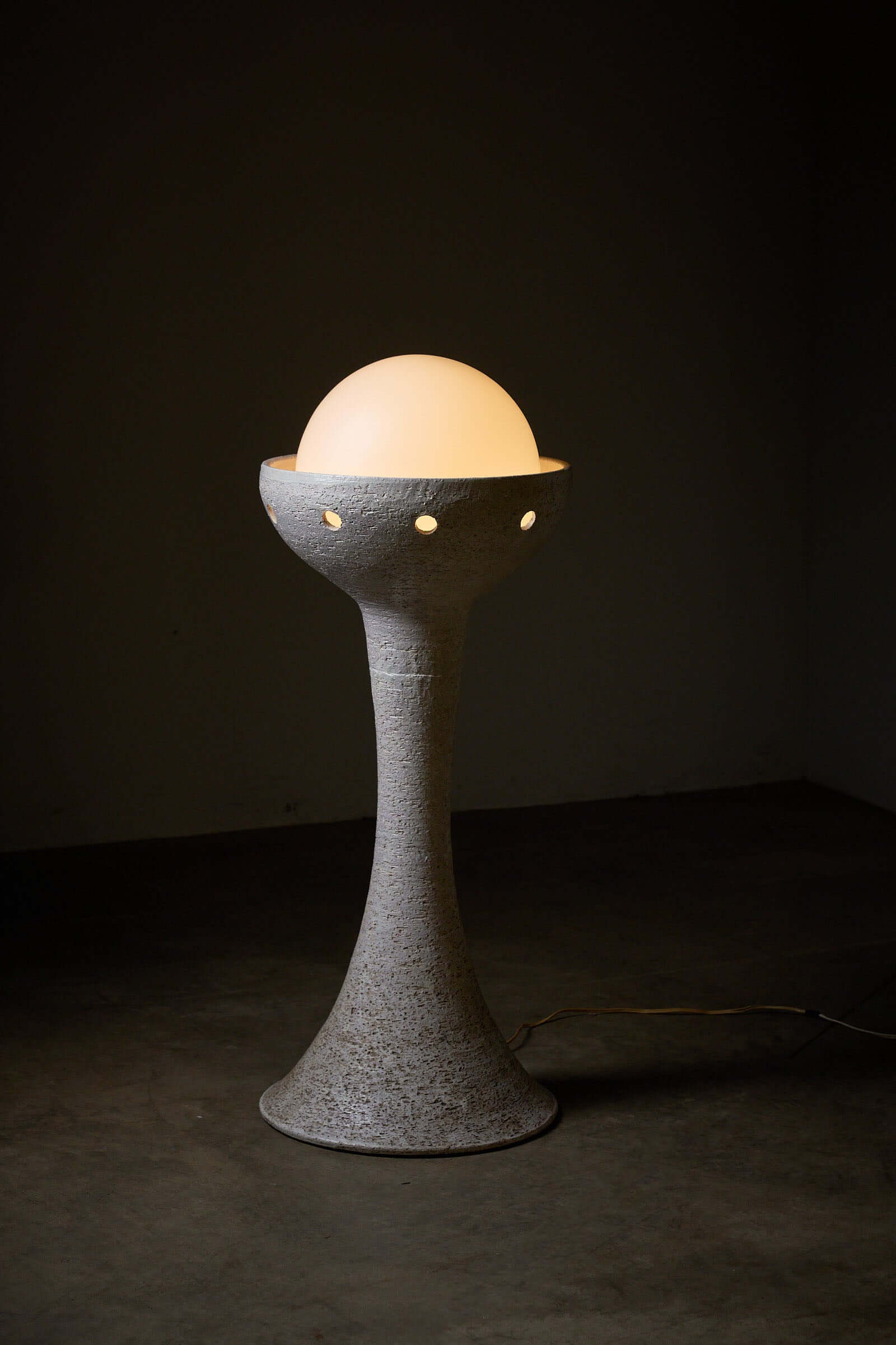 Natural ceramic floor lamp with glass sphere diffuser and white textured finish by BEGA standing tall at 95cm