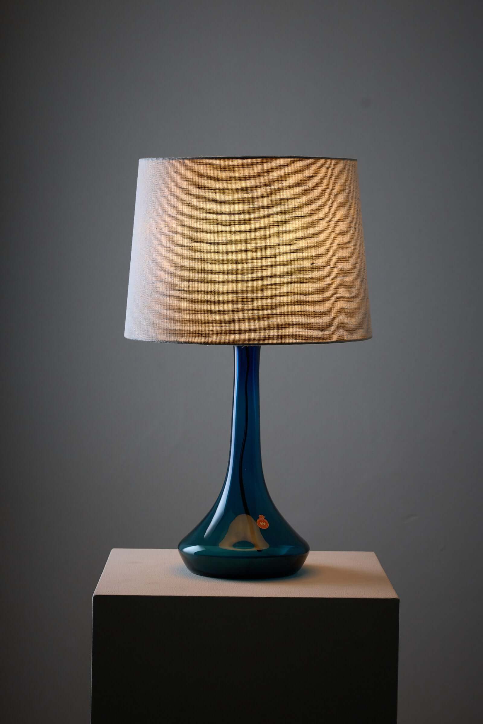 Elegant blue Holmegaard glass table lamp with fabric shade, designed by Lisbeth Brams for Fog & Mørup.