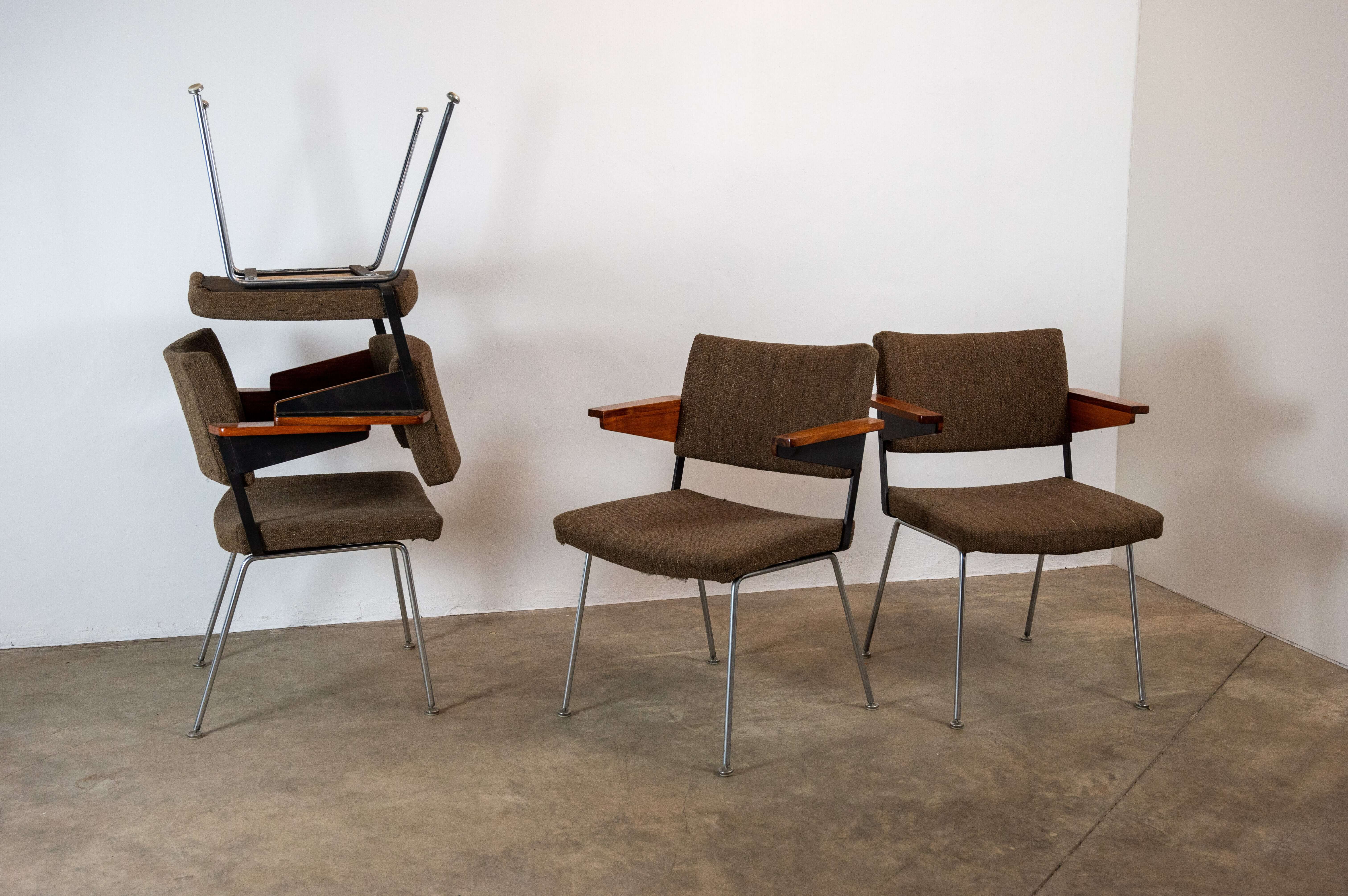 Set of 8 mid-century Gispen L11 armchairs by A.R. Cordemeyer with wooden armrests and chromed steel legs, arranged in a modern setting