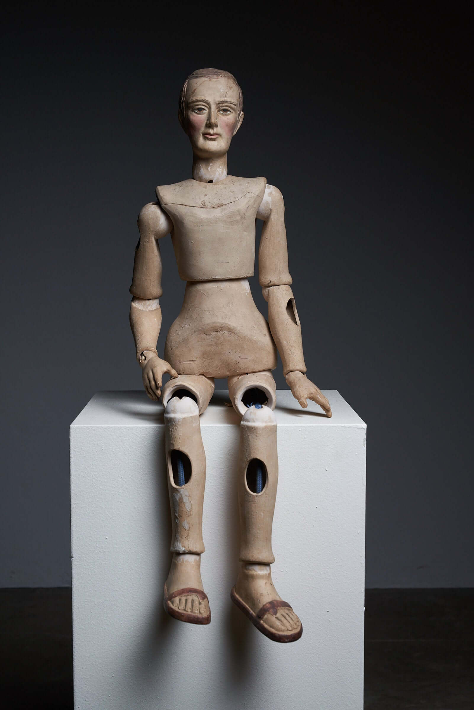 Antique terra cotta articulated mannequin from the early 20th century with lifelike features and movable joints on display.