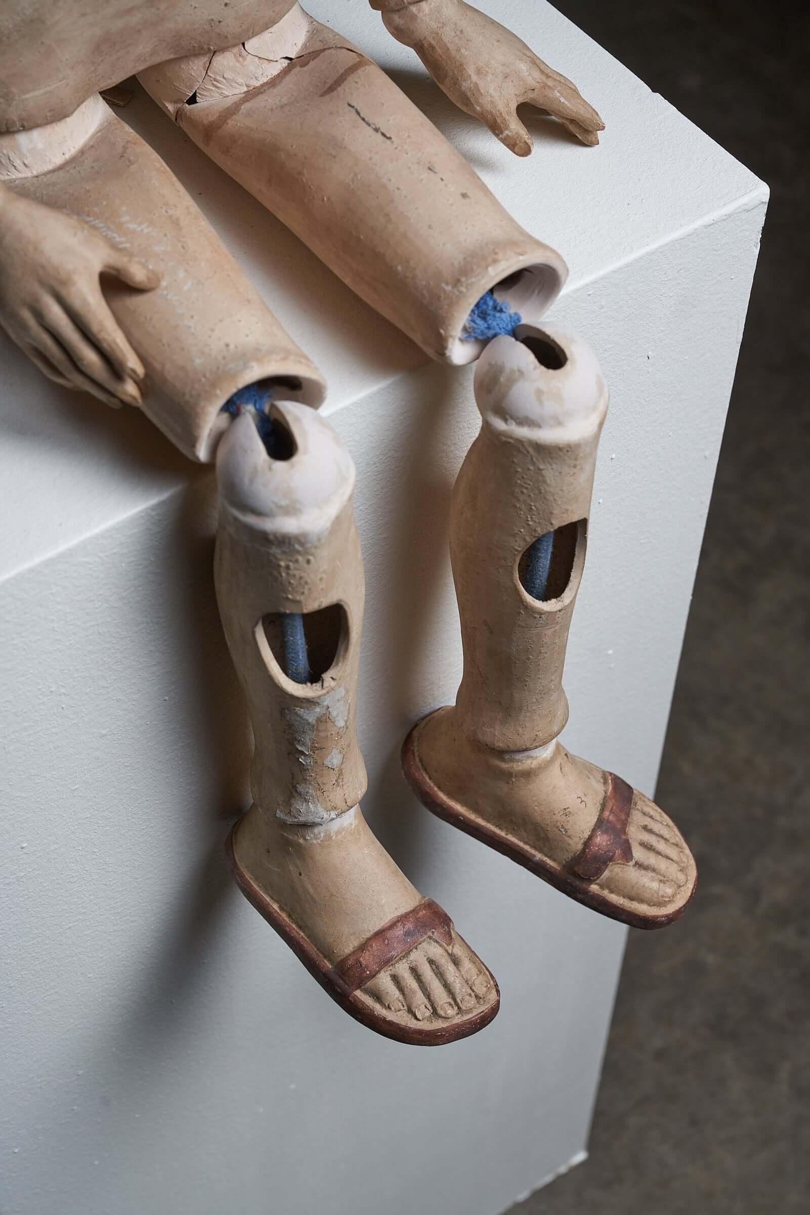 Antique terra cotta articulated mannequin legs from early 20th century with movable joints and detailed craftsmanship