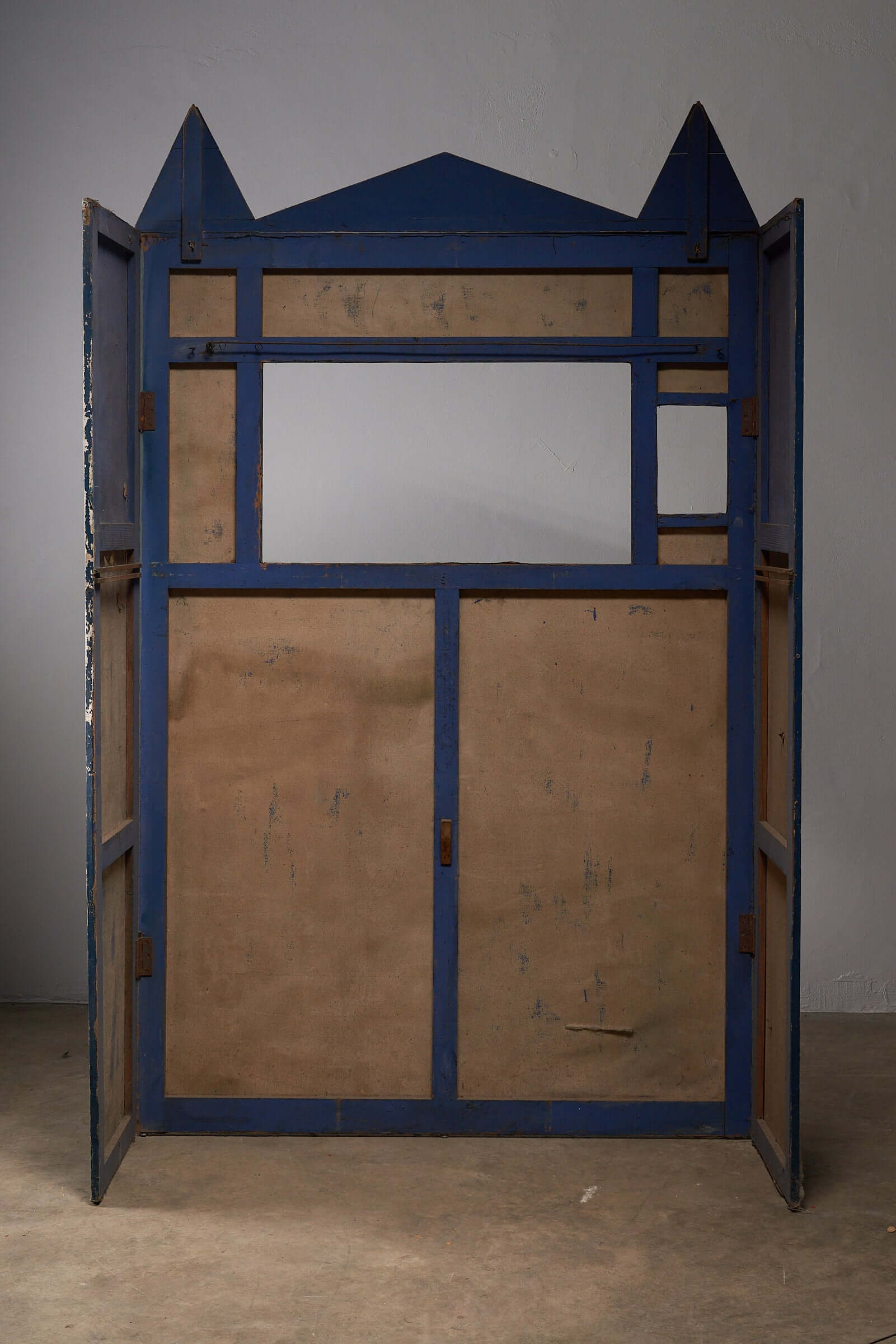 Antique hand-painted puppet theater backdrop frame in blue tones from the early 20th century.