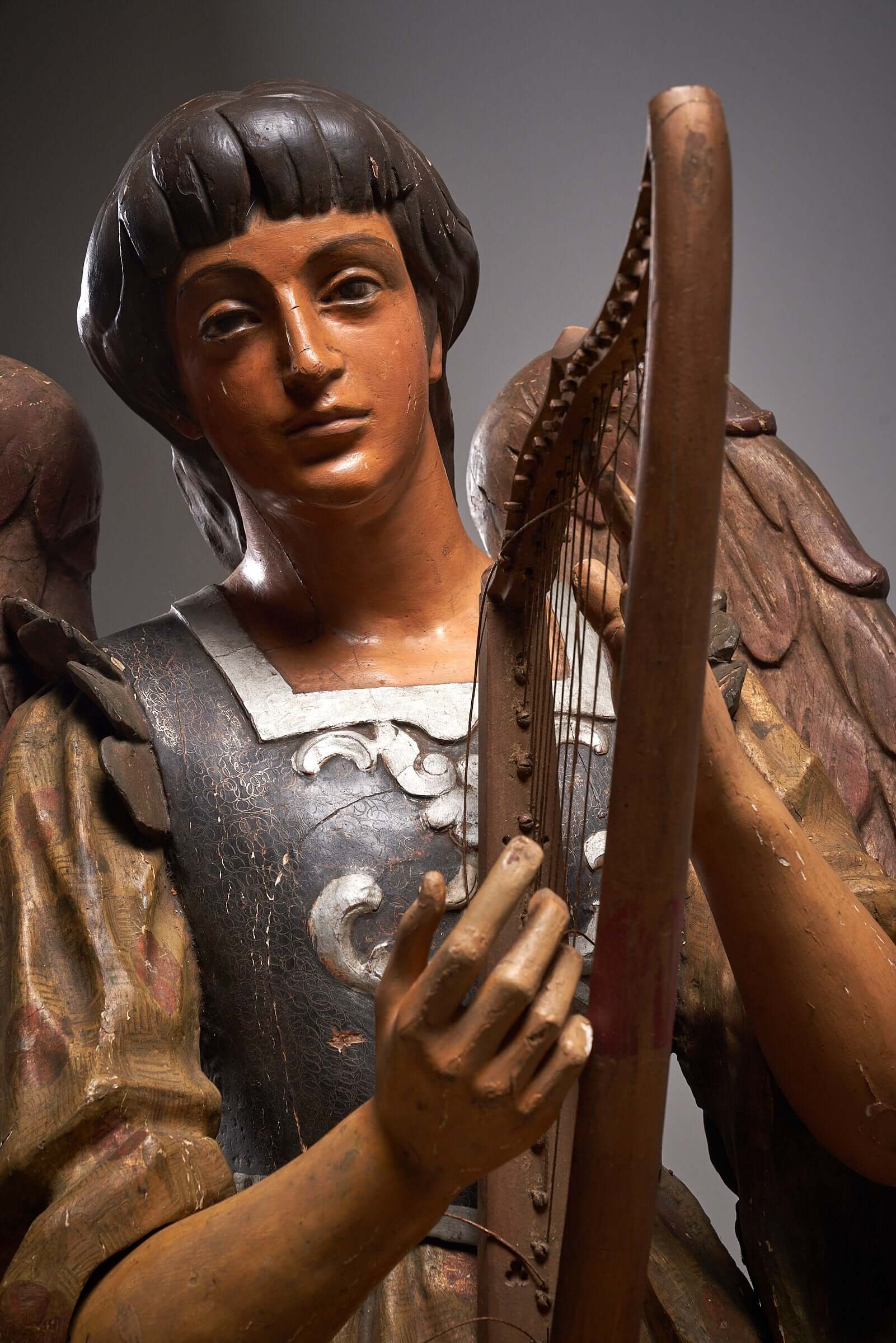 Antique hand-painted wooden angel with harp sculpture, showcasing detailed wings and serene expression, 19th-century religious art