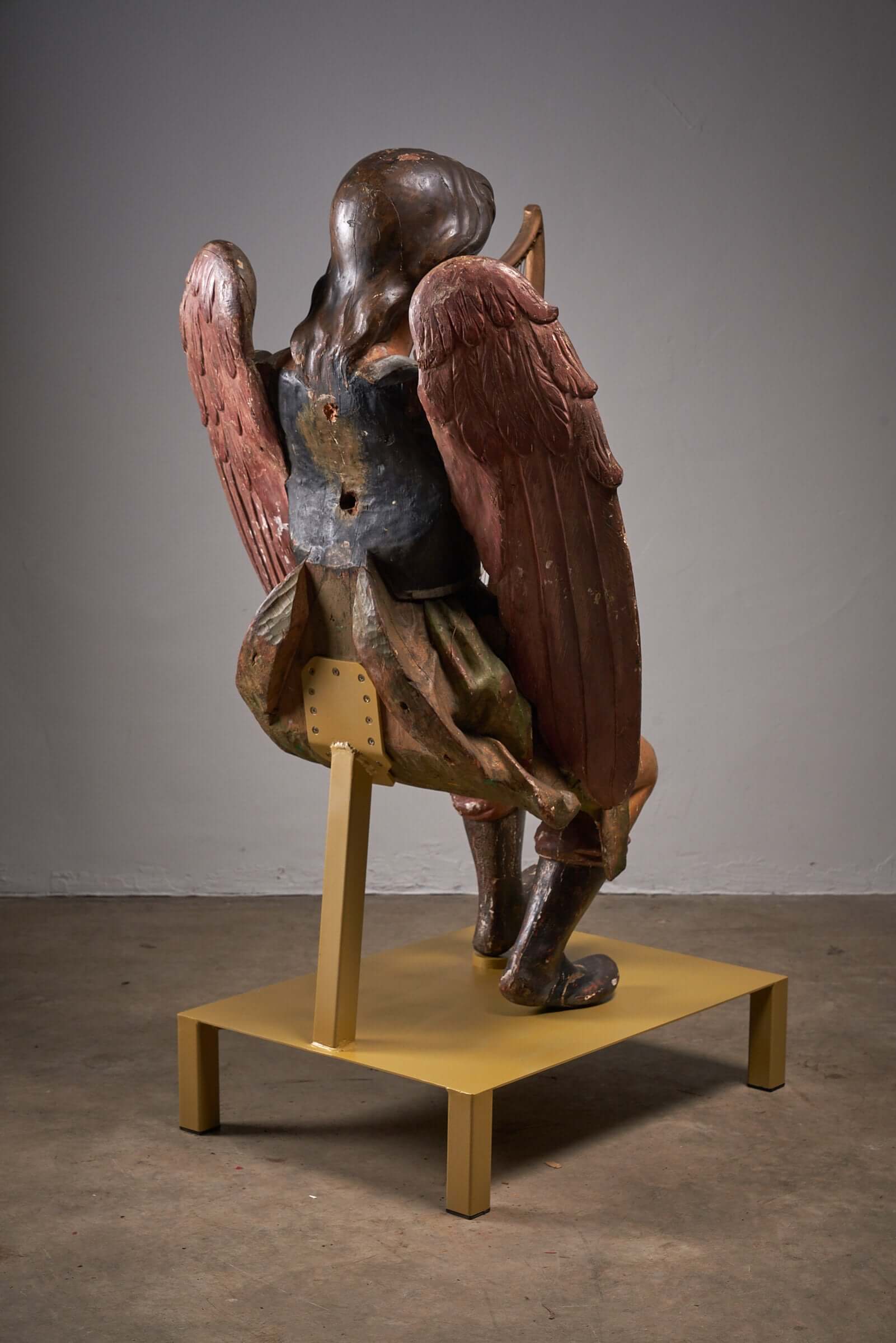 Antique hand-painted wooden angel with harp, 19th-century religious sculpture, detailed carving and aged paintwork.